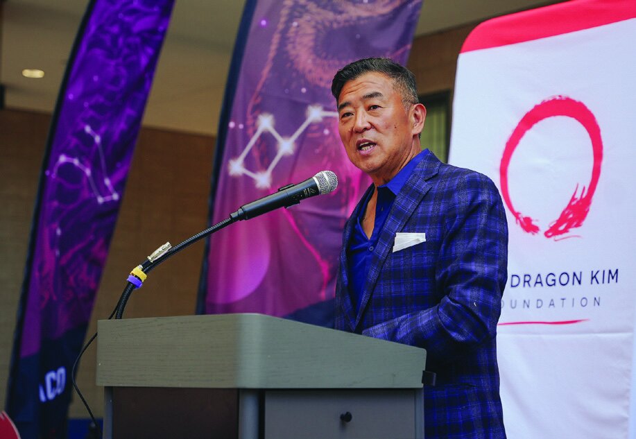 Daniel Kim speaking at a Dragon Kim Foundation event
